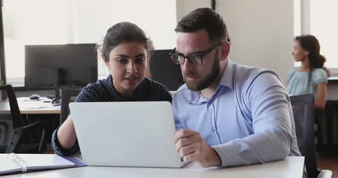 Indian mentor telling to apprentice about new corporate software Video stock 170652263
