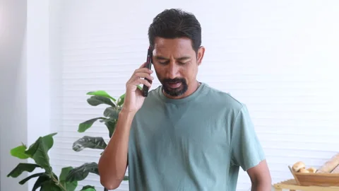 Indian middle-aged man, freelancer, business people talking to mobile phone.. Stock Footage 254657513