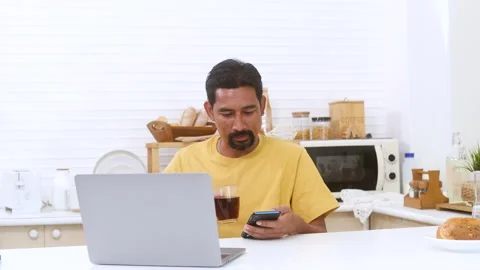 Indian middle-aged worker, freelancer working in domestic kitchen, single A.. Stock Footage 254668734