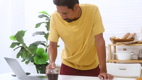 Indian middle-aged worker, freelancer working in domestic kitchen, single A.. Stock Footage 254714220