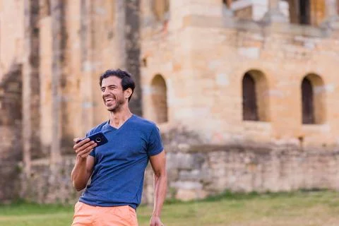 Indian model, mature man dancing Bollywood with smartphone music. Europe travel Stock Photos