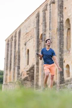 Indian model, mature man dancing Bollywood with smartphone music. Europe travel Stock Photos