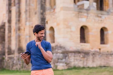 Indian model, mature man dancing Bollywood with smartphone music. Europe travel Stock Photos