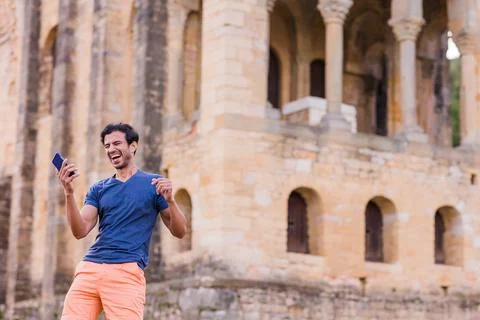Indian model, mature man dancing Bollywood with smartphone music. Europe travel Stock Photos