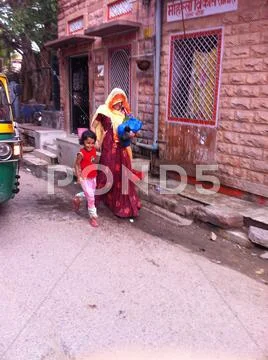 Indian mother takes child to school Stock Photos
