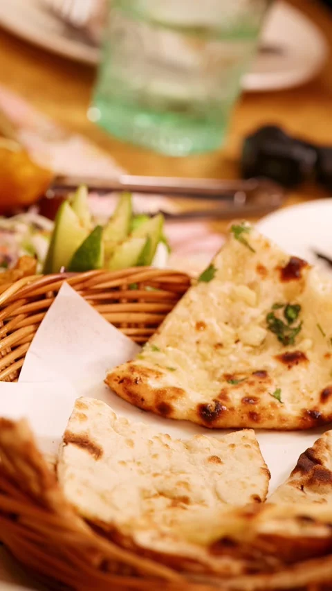Indian Naan Bread and Appetizers Served in Wicker Basket Video stock 339065498