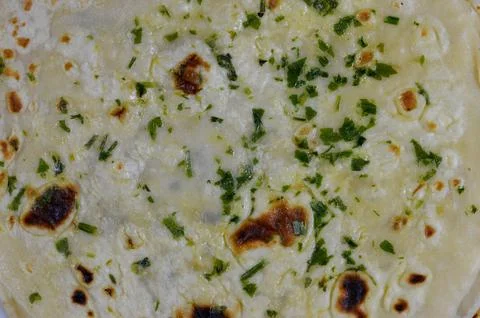 Indian naan bread baked inside a very hot clay tandoor oven, delicious, sof.. Stock-Fotos