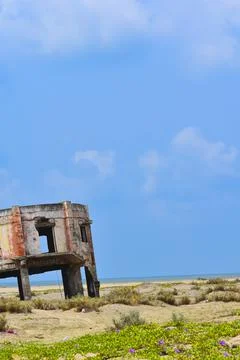 INDIAN OCEAN. An old decrepit white building faces the sea near the Beach. Stock Photos