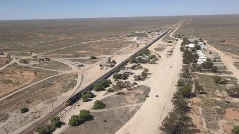 Indian Pacific Train Refuelling at Cook Staion Nullarbor Drone Arial Desert Stock Footage 128937040