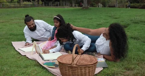 Indian parents having fun at city park painting with their children Stock Footage 154794053