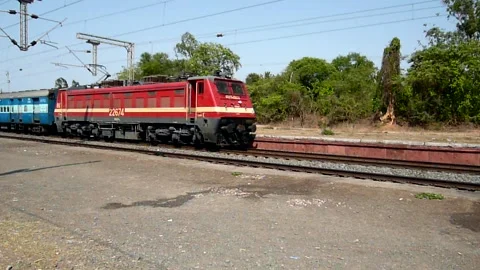 Indian Passenger Express Train speeding at Sanjan Railway station Gujarat India Stock Footage 131084788