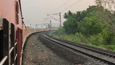 Indian Passenger Train Navigating Curved Railway Tracks POV Stock Photos