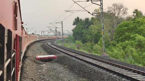 Indian Passenger Train Navigating Curved Railway Tracks POV Stock Photos