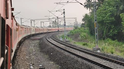 Indian Passenger Train Navigating Curved Railway Tracks POV Stock Photos
