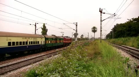 Indian passenger train passes by suburbs of Bangalore, Karnatak Stock Footage 20592111