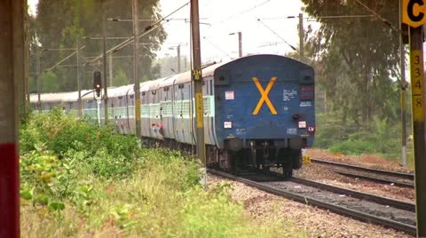 Indian passenger train passes by suburbs of Bangalore, Karnatak Stock Footage 20592280