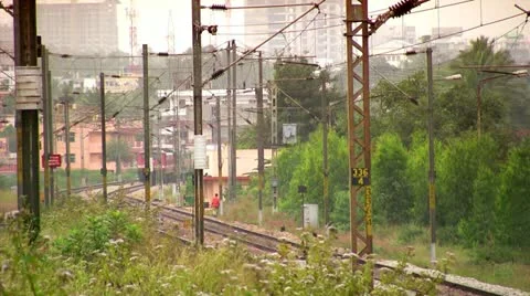 Indian passenger train passes by suburbs of Bangalore, Karnatak Stock Footage 20592476