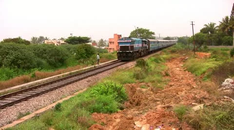 Indian passenger train passes by suburbs of Bangalore, Karnatak Stock Footage 20593375