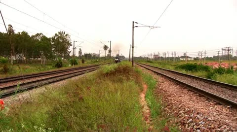 Indian passenger train passes by suburbs of Bangalore, Karnataka, India. Stock Footage 20604153