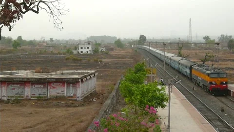 Indian Passenger Train speeding crossing beautiful railway station, Mumbai India Stock Footage 132993266