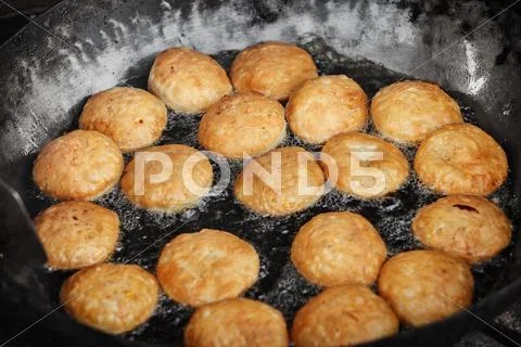 Indian pastries in a pan on the open market Stock Photos