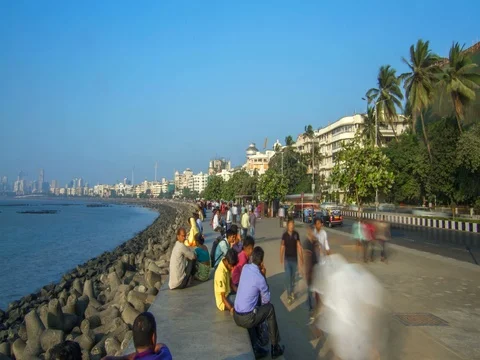 Indian People are resting at seafront at Marine drive, Mumbai, India Stock Footage 77949836