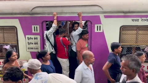 Indian people commuting on a packed local train during rush hour in Mumbai Stock Footage 341455708