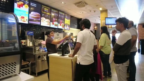 Indian People stand in line inside fast food restaurant. Stock Footage 192244859