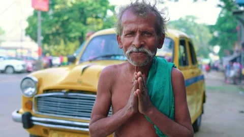 Indian poor old labourer man standing making a Namaste gesture looking at camera Stock Footage 266127583