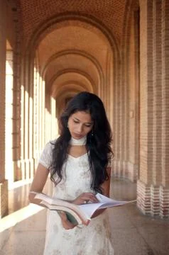 Indian professor walking in corridor. Stock Photos