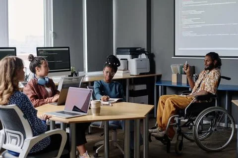 Indian Programmer in Wheelchair Giving Presentation at Office Business Meeting Stock Photos
