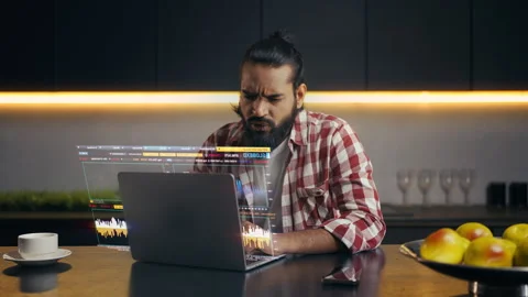 Indian programmer working on laptop with holographic screen faces hacking attack Stock Footage 329506555
