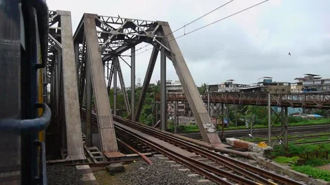 Indian Rails passenger express train crossing Metal Railway Bridge Mumbai India Stock Footage 139327587