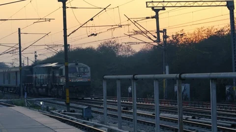 Indian Railway Train Running on Tracks at Sunset Stock Footage 328653697