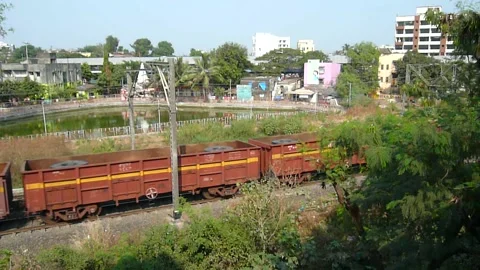 Indian railways Freight cargo container Train crossing countryside Mumbai India Stock Footage 131098111
