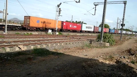 Indian Railways Freight cargo container Industrial Train moving at station India Stock Footage 136751517