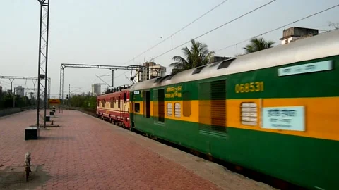 Indian railways New Express Train Crossing Dahisar Railway station Mumbai India Stock Footage 153162583