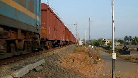 Indian Railways Old red Freight Goods Train in Motion crossing station India Stock Footage 134894837