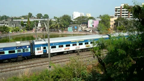 Indian Railways Passenger Express Train speeding scenic Aerial view Mumbai India Stock Footage 131097798