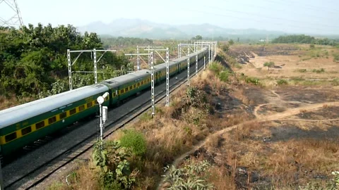 Indian Railways Passenger Express Train speeding Aerial view Bridge Mumbai India Stock Footage 131099028