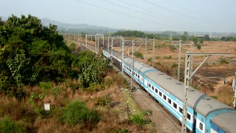 Indian Railways Passenger Express Train speeding Aerial view Bridge Mumbai India Stock Footage 131099512