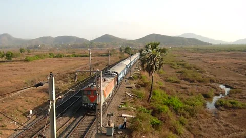 Indian Railways Passenger Express Train speeding countryside Aerial Mumbai India Stock Footage