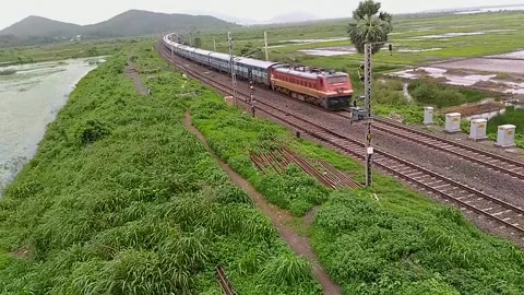 Indian Railways Passenger Express Train speeding countryside Aerial Mumbai India Stock Footage 141566447