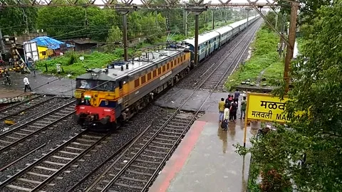 Indian Railways Passenger Train moving Aerial Countryside Malavli Station India Stock Footage 137807958