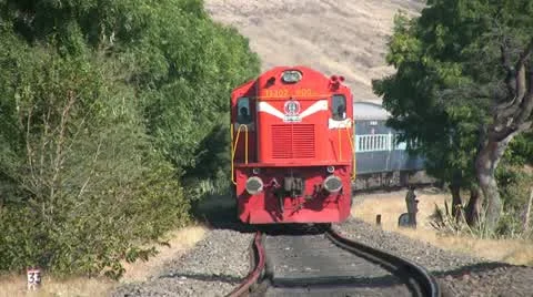 Indian railways passenger train passes by in a mountainous countryside. Stock Footage 11353335