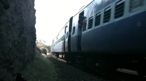 Indian railways passenger train passes by in a mountainous countryside. Stock Footage 11353845