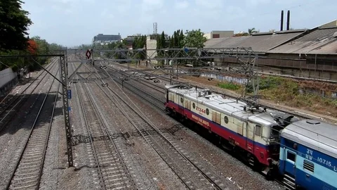 Indian railways passenger Train speeding near Vile Parle station, Mumbai India Stock Footage 107460169