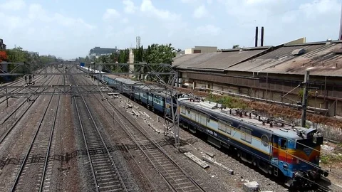 Indian railways passenger Train speeding near Vile Parle station, Mumbai India Stock Footage 107460402