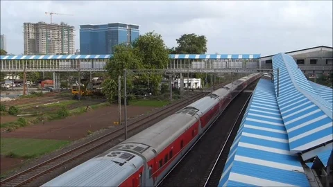 Indian railways Rajdhani Express Train Crossing Railway station, Mumbai India Video stock 98849121