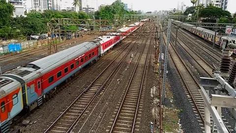 Indian railways Rajdhani Express Train Crossing with speed, Mumbai India Stock Footage 106343570